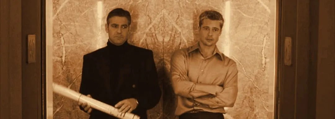 Danny and Rusty holding a roll of blueprints