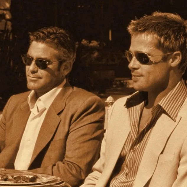 Danny and Rusty in sunglasses at a sunny lunch table, tungsten tone