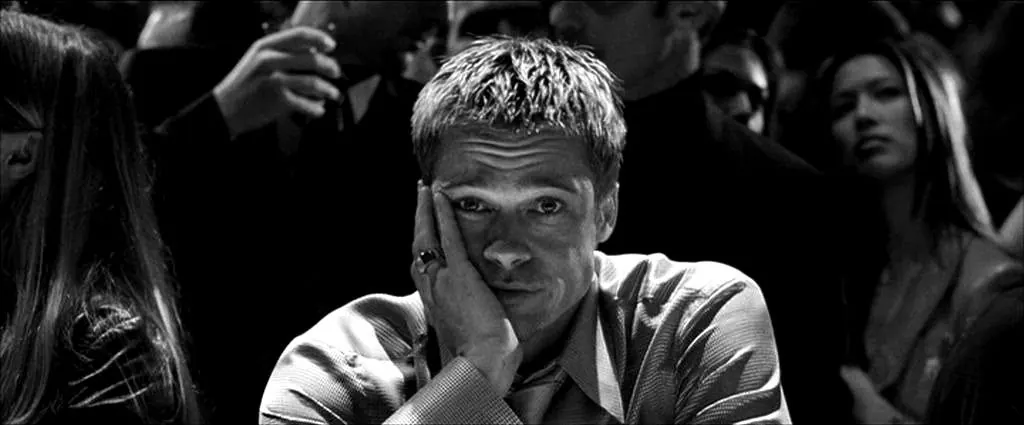 Rusty resting his face on his hand in a crowd