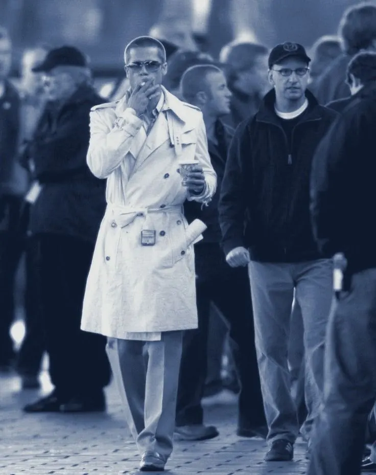 Rusty in a white coat walking with the crew