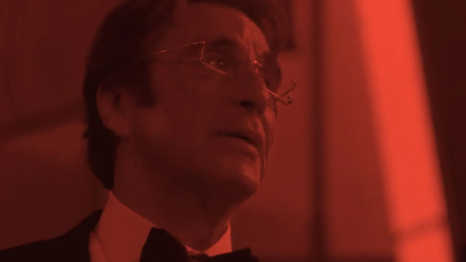 Willy Bank in close-up under red light